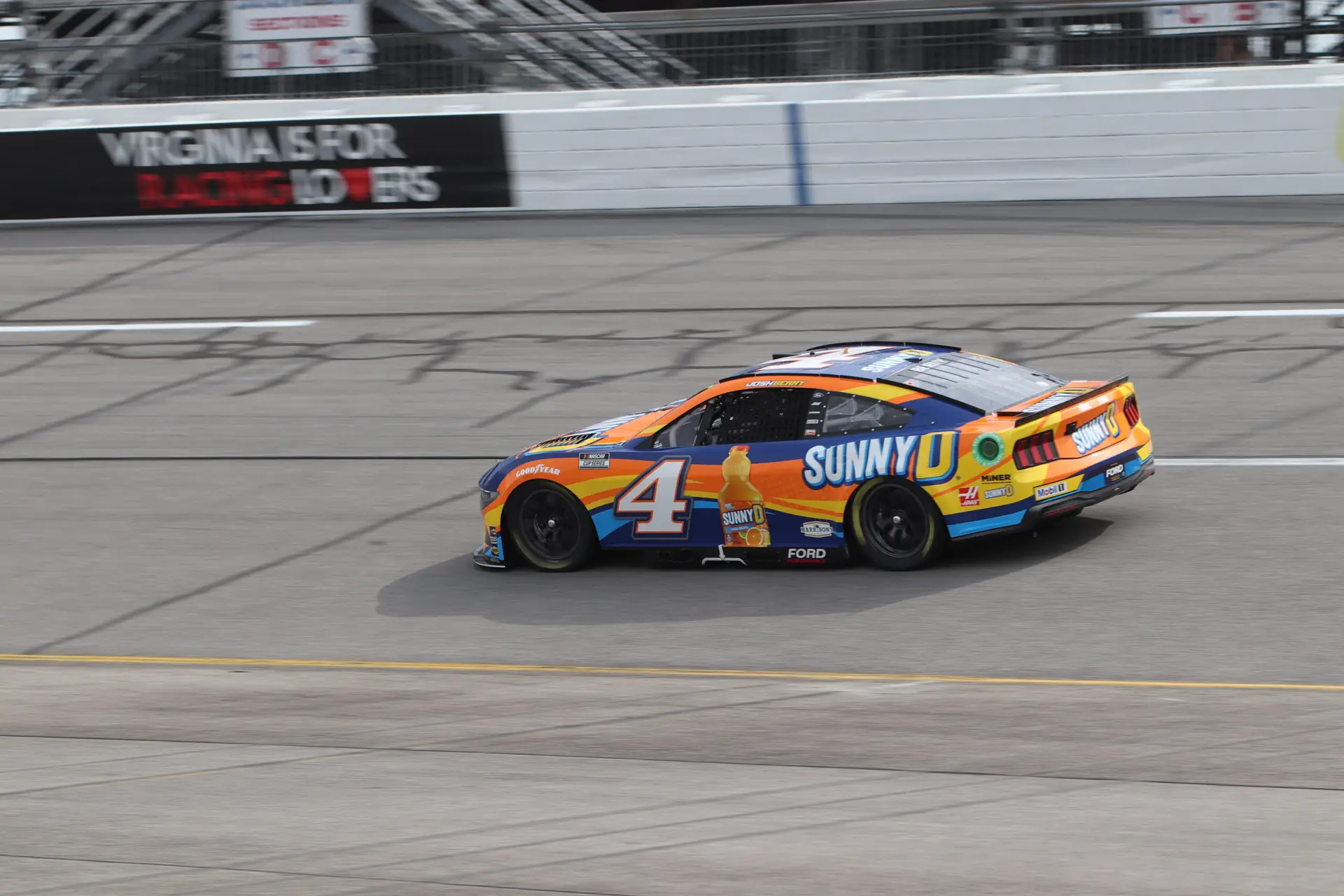 Josh Berry wheels his No. 4 orange and blue Sunny D's Stewart-Haas Racing Ford around the track.