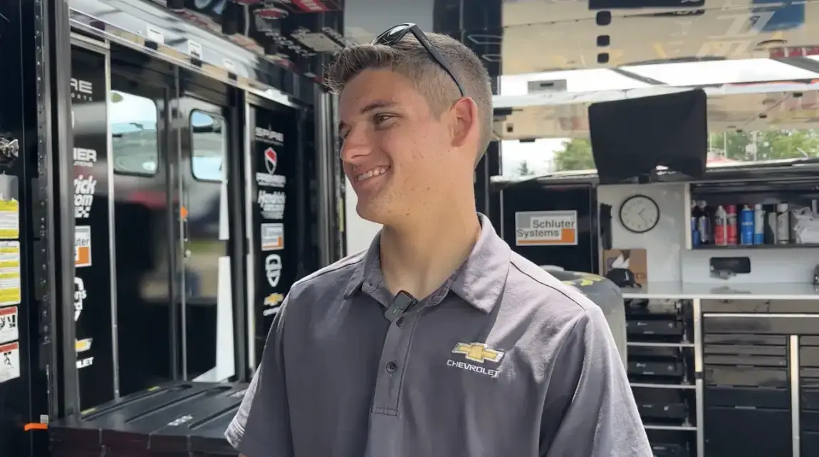 Landen Lewis stands at his truck hauler in a Chevrolet polo ahead of his first NASCAR Truck Series start.
