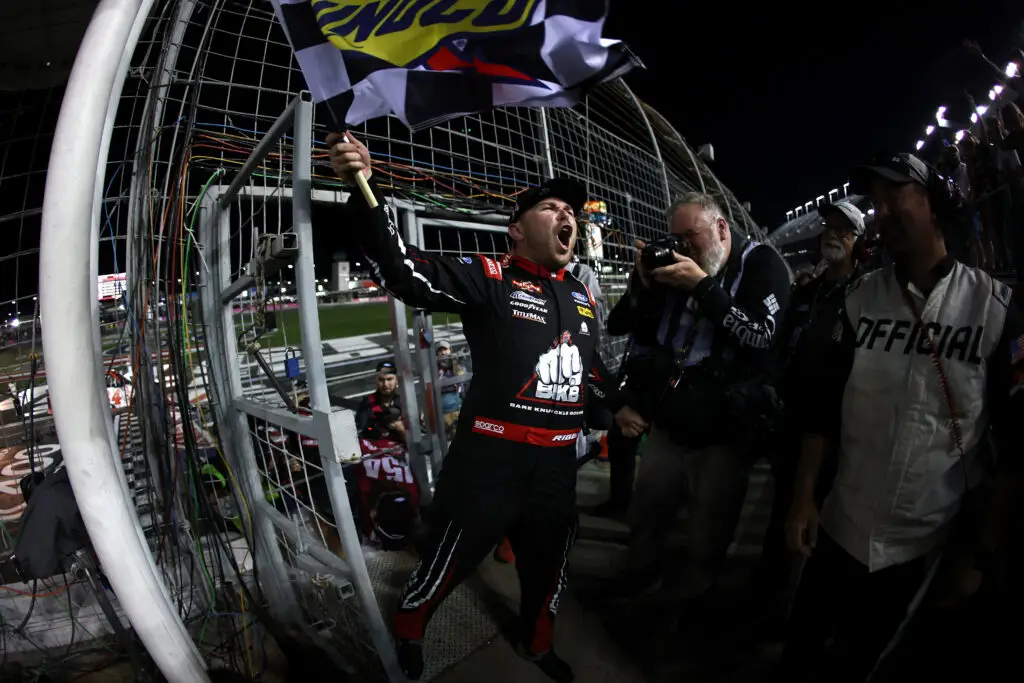 Credit: CONCORD, NORTH CAROLINA - OCTOBER 09: Layne Riggs, driver of the #34 BKB Bare Knuckle Boxing Ford, celebrates with the checkered flag after winning the NASCAR Craftsman Truck Series Ecosave 200 at Charlotte Motor Speedway on October 09, 2026 in Concord, North Carolina. (Photo by Jared C. Tilton/Getty Images)