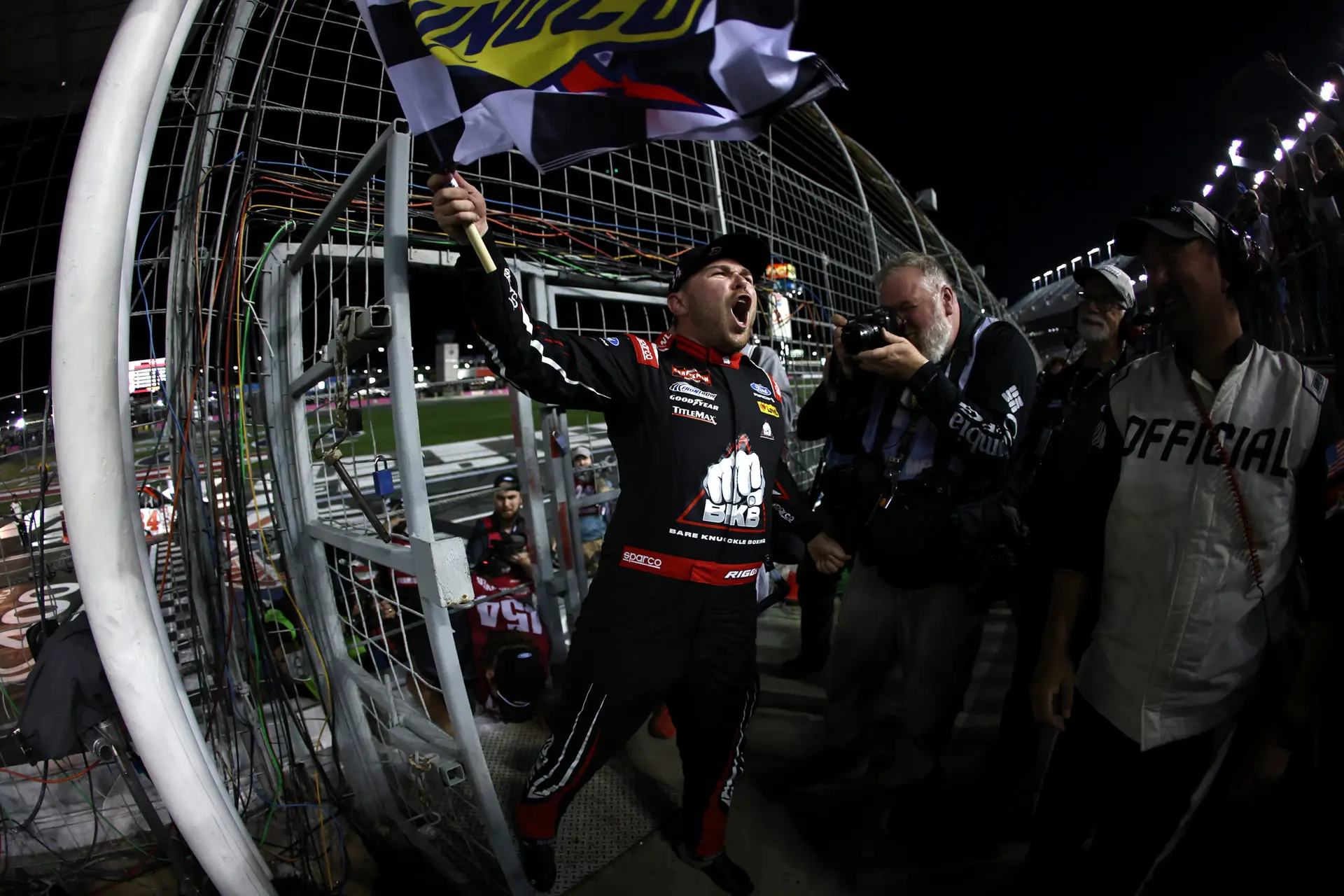 Credit: CONCORD, NORTH CAROLINA - OCTOBER 09: Layne Riggs, driver of the #34 BKB Bare Knuckle Boxing Ford, celebrates with the checkered flag after winning the NASCAR Craftsman Truck Series Ecosave 200 at Charlotte Motor Speedway on October 09, 2026 in Concord, North Carolina. (Photo by Jared C. Tilton/Getty Images)